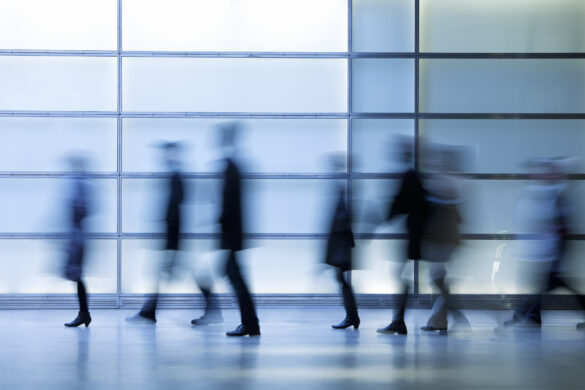 Commuters Walking in Modern Glass Interior, Blurred Motion